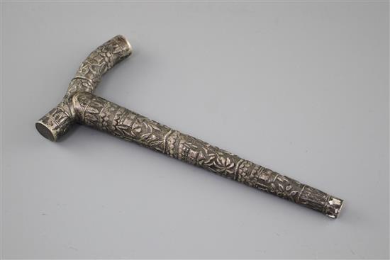 An Indian? embossed white metal cane handle, unmarked, 21.5cm, 2.5oz.
